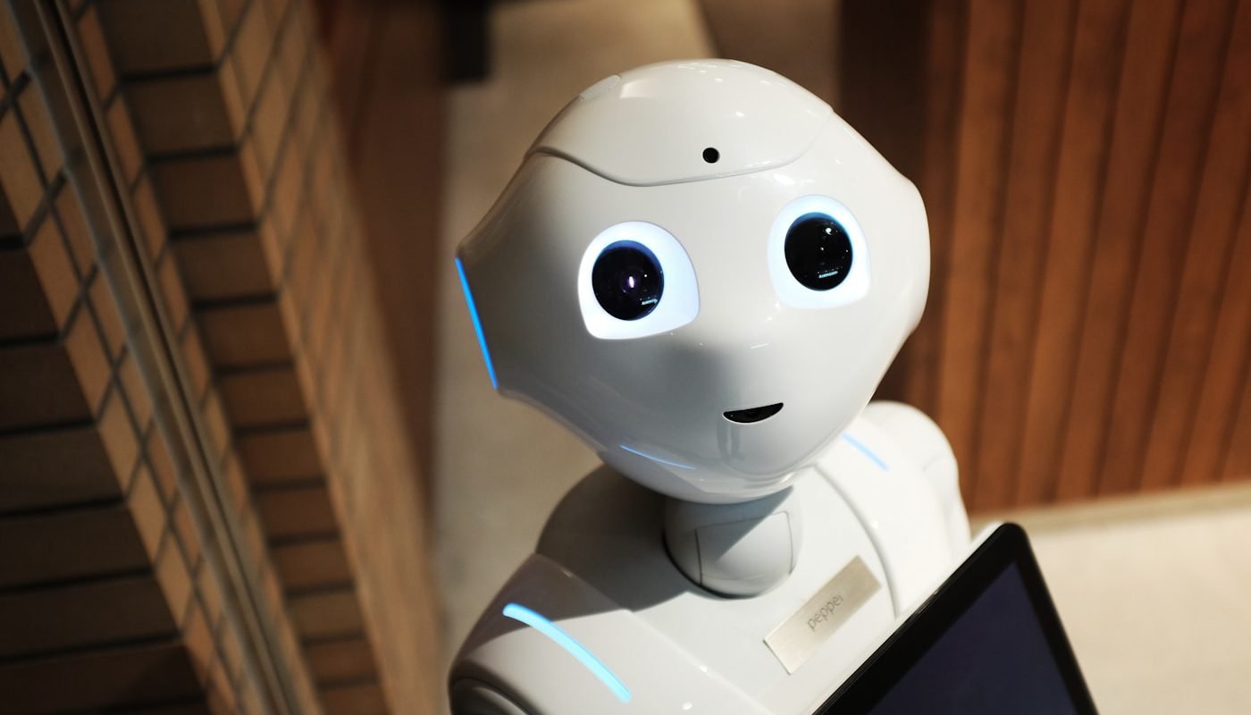 Small white household robot in a home hallway